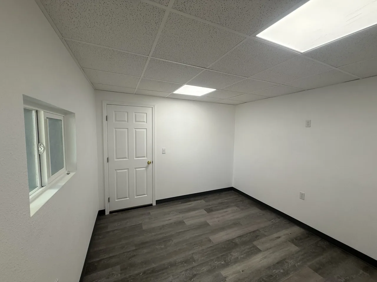 Finished office interior with windows, a door and flooring