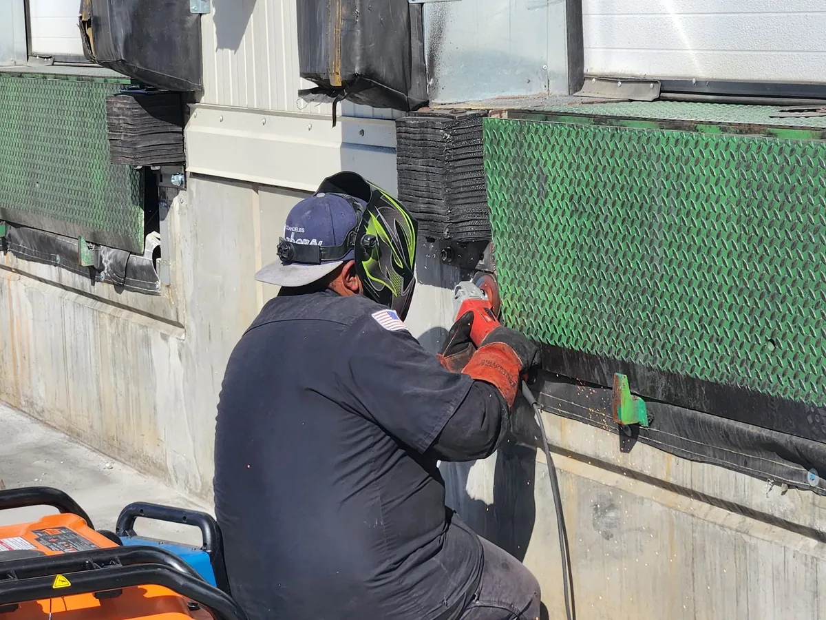 Technician working on a loading dock bumper
